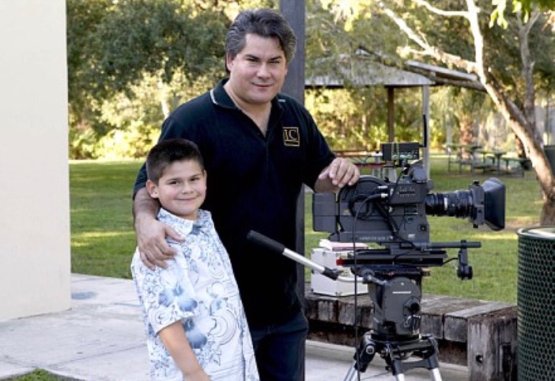 Young Javi with his dad next to a cinema camera