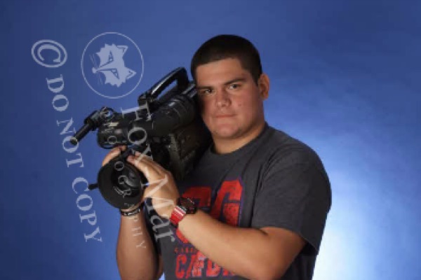 High school Javi with a professional camera on his shoulder