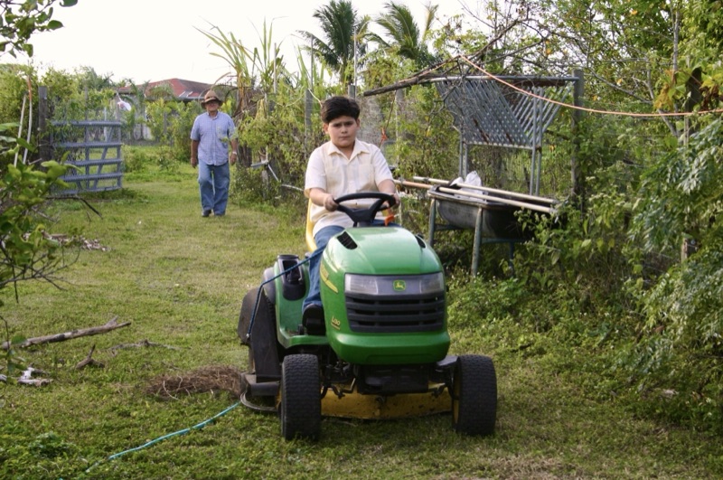 Young Javi on a riding lawnmower in Miami